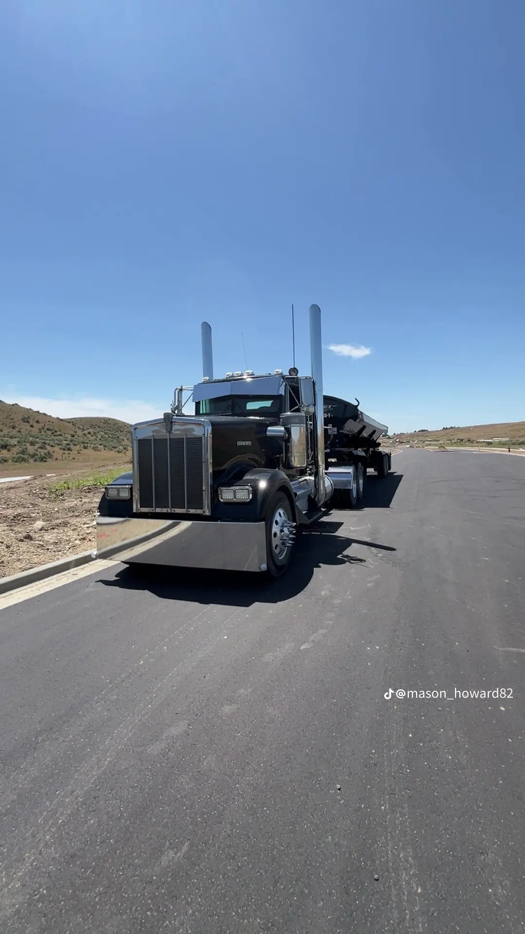 Black Kenworth on road